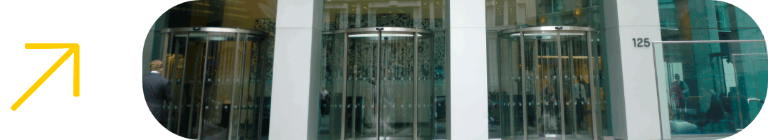 Flecha amarilla e imagen de la entrada de unas oficinas empresariales