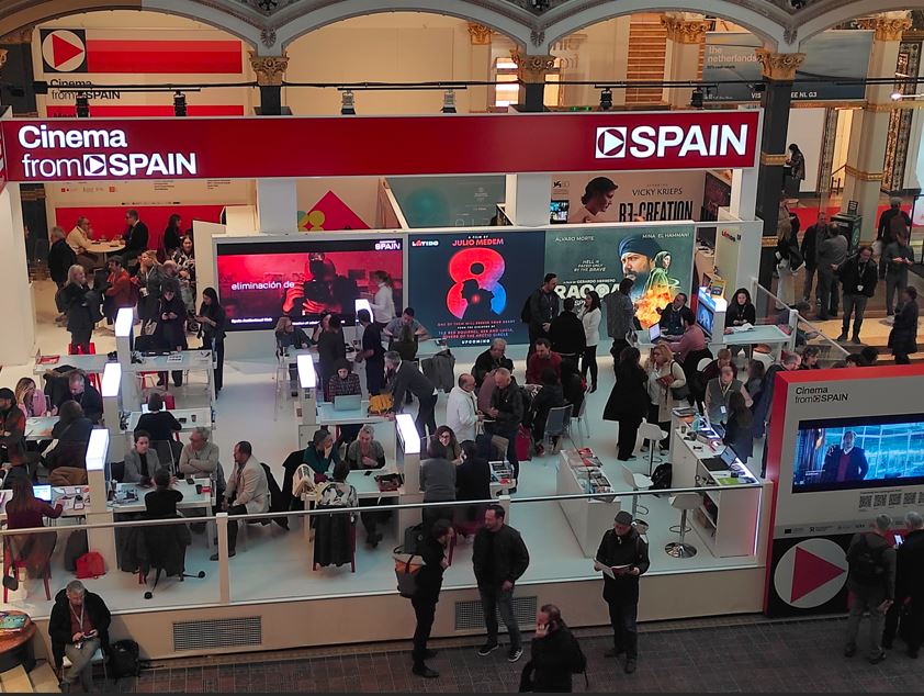 Panorámica de la zona de mesas de reuniones del Pabellón Cinema from Spain, con varias personas celebrando reuniones.