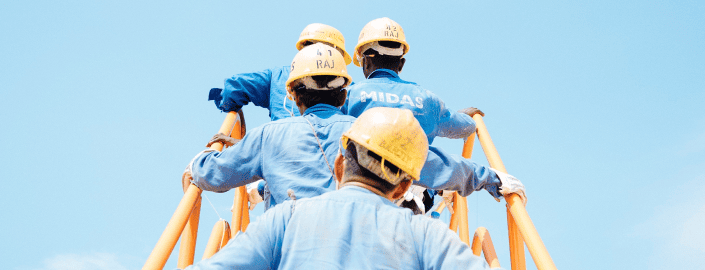 Grupo de trabajadores con casco subiendo escaleras