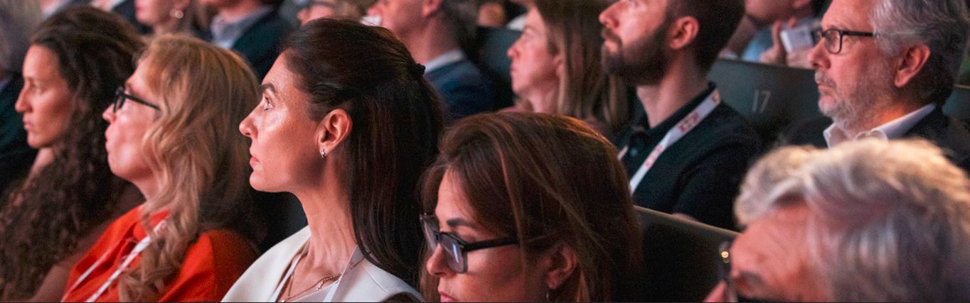 Varios consejeros y el resto del público atienden a una ponencia