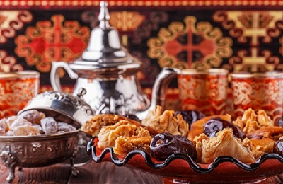 Moroccan mint tea in the traditional glasses with sweets, selective focus.