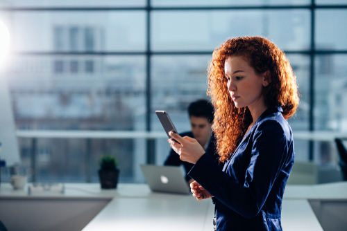 caucasian Businesswoman Outside Office On Mobile Phone