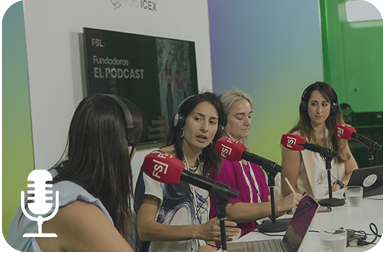 Cuatro mujeres sentadas en una mesa delante de micrófonos